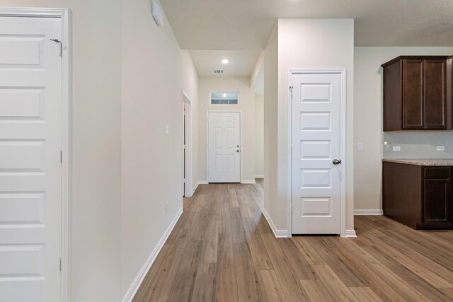 hall with light wood-type flooring