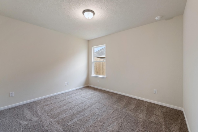 unfurnished room featuring a textured ceiling and carpet