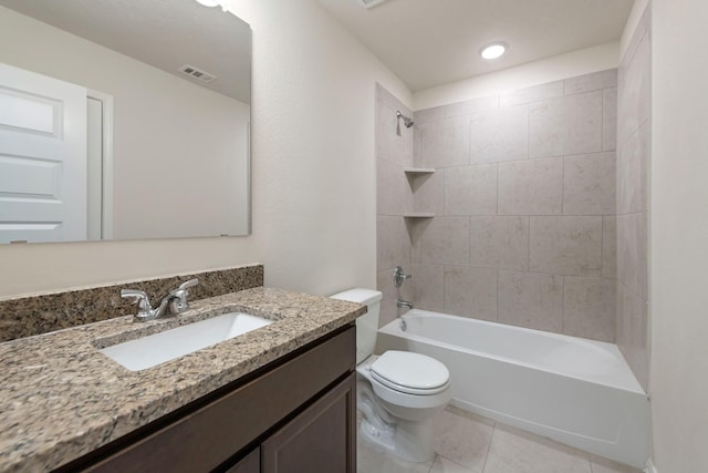 full bathroom with tile patterned floors, vanity, toilet, and tiled shower / bath combo