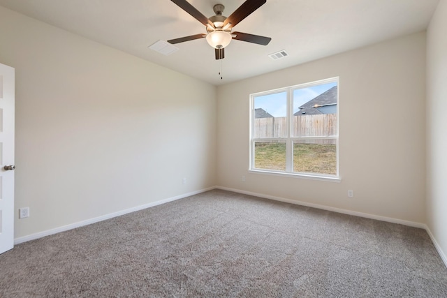 carpeted spare room featuring ceiling fan