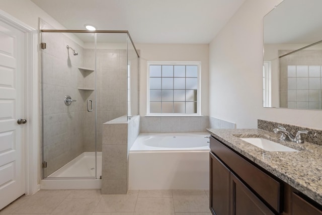 bathroom with shower with separate bathtub, tile patterned floors, and vanity