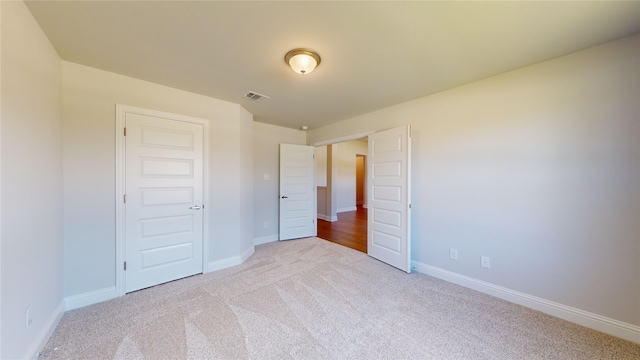 unfurnished bedroom with light carpet