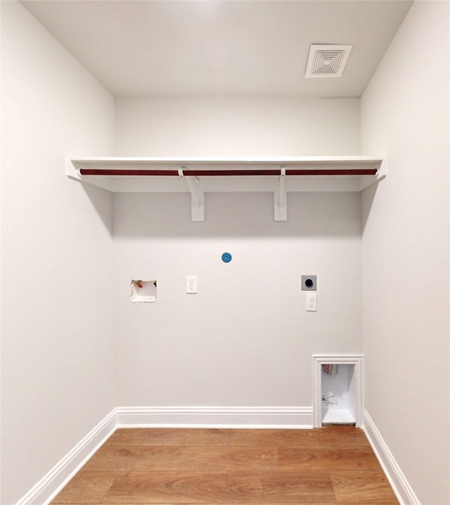 washroom featuring washer hookup, light wood-type flooring, and electric dryer hookup