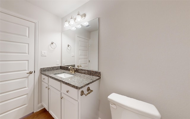 bathroom featuring vanity and toilet