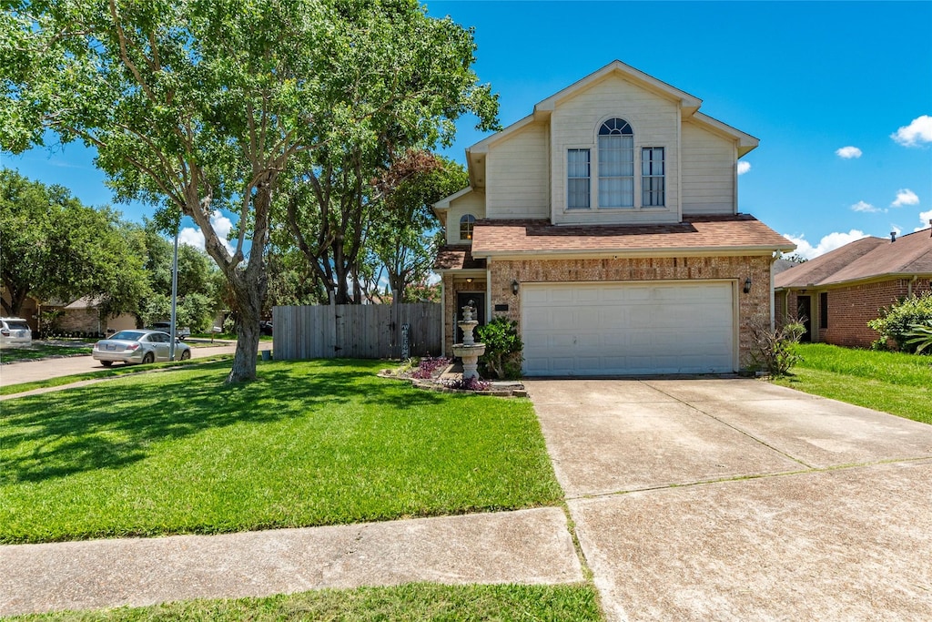 view of front property featuring a garage and a front lawn