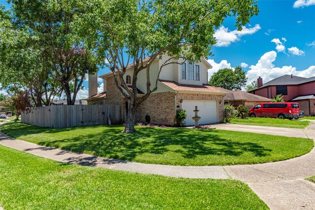 view of front of home with a garage and a front lawn