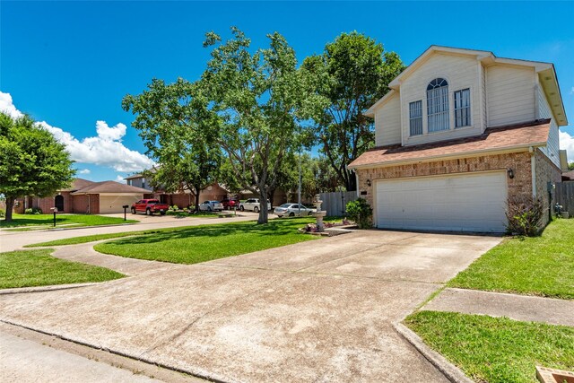 view of front of home with a garage and a front lawn