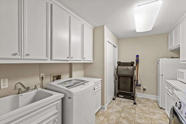 laundry area with cabinets, sink, light tile patterned floors, and independent washer and dryer