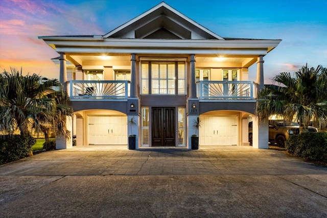 coastal home with a garage and a balcony