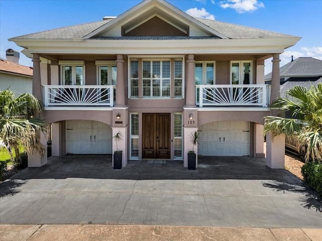 view of front of house with a garage and a balcony