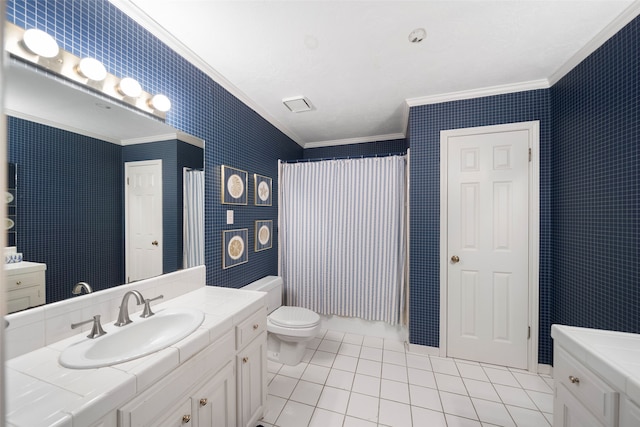 bathroom featuring toilet, ornamental molding, vanity, and tile patterned floors