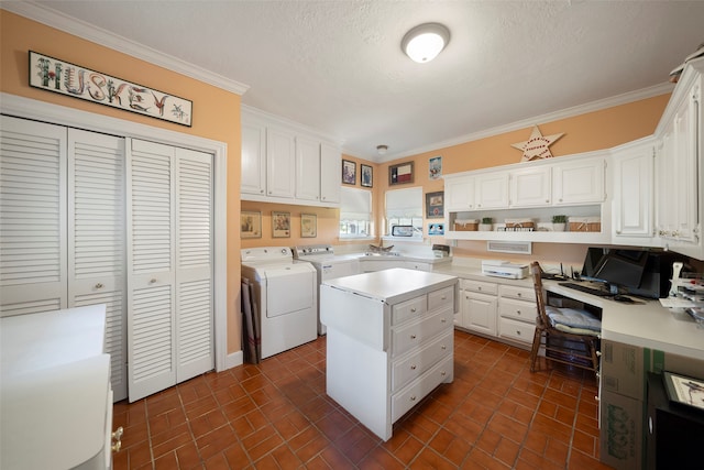 laundry room with ornamental molding, independent washer and dryer, and a textured ceiling