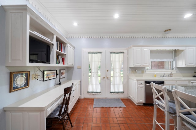 kitchen featuring stainless steel dishwasher, sink, french doors, and white cabinetry