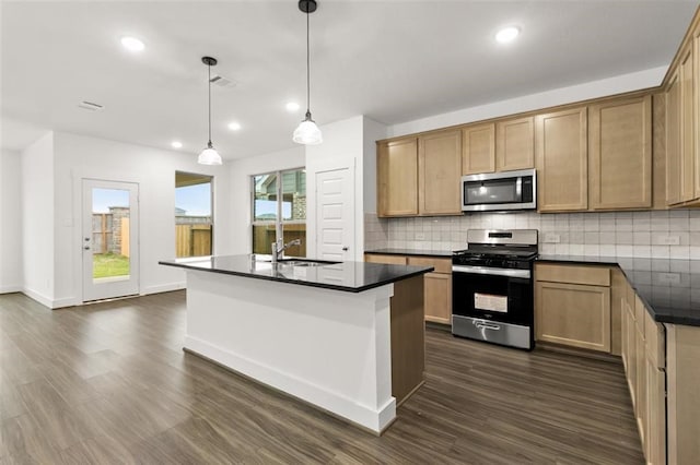 kitchen with pendant lighting, appliances with stainless steel finishes, a healthy amount of sunlight, and dark hardwood / wood-style floors