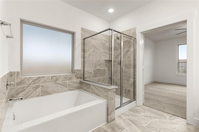 bathroom featuring shower with separate bathtub