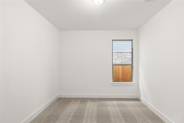 unfurnished room featuring baseboards and carpet floors