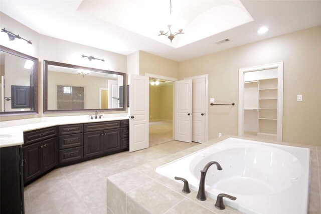 bathroom with tile floors, tiled bath, and double sink vanity