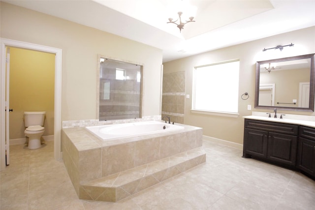 bathroom featuring tile flooring, toilet, plenty of natural light, and tiled bath