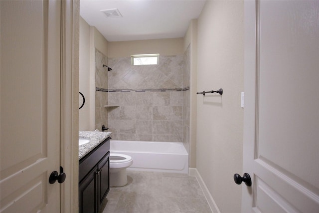 full bathroom with tile flooring, tiled shower / bath combo, vanity, and toilet