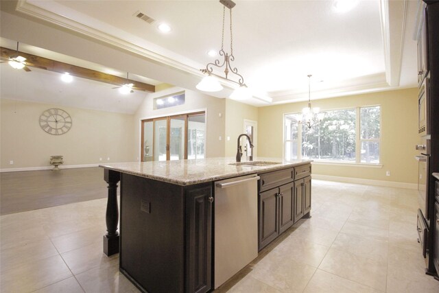 kitchen with stainless steel appliances, an island with sink, ceiling fan with notable chandelier, dark brown cabinets, and decorative light fixtures