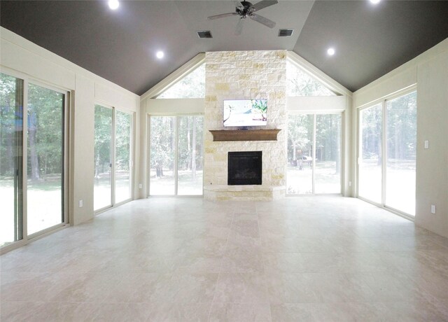 unfurnished living room featuring a healthy amount of sunlight, a fireplace, and tile floors