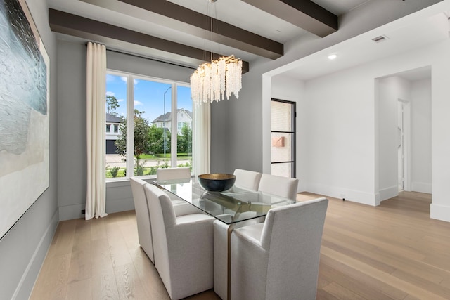 dining area featuring an inviting chandelier, light hardwood / wood-style floors, and beamed ceiling