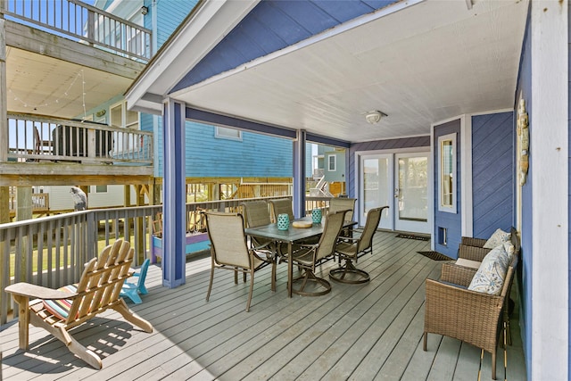 wooden deck featuring french doors and an outdoor hangout area