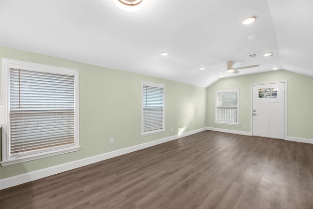 interior space featuring dark wood-type flooring, vaulted ceiling, and ceiling fan