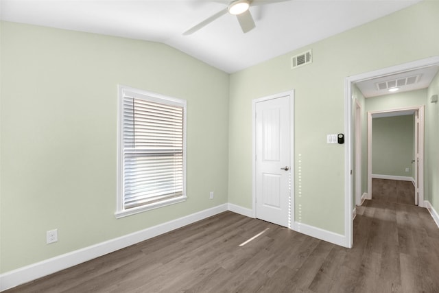 unfurnished bedroom with hardwood / wood-style floors, a closet, vaulted ceiling, and ceiling fan