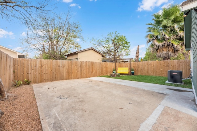 view of yard featuring cooling unit and a patio