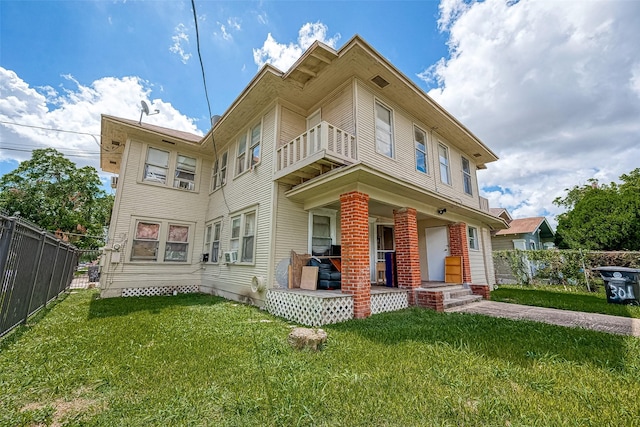 exterior space with a yard, a balcony, and a porch