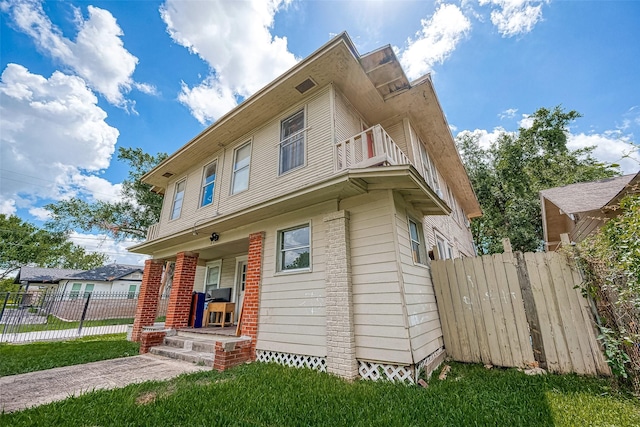 view of front of home featuring a porch and a balcony