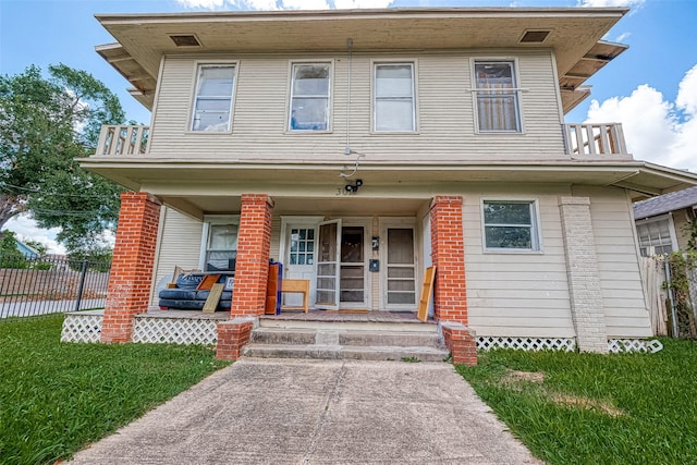 view of front of property with covered porch and a front lawn