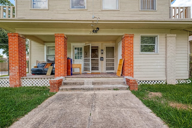 view of exterior entry with covered porch