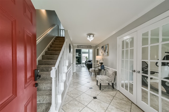 interior space featuring ornamental molding, light tile flooring, and french doors