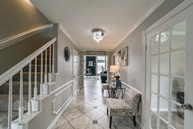 corridor with crown molding, a chandelier, and light tile floors