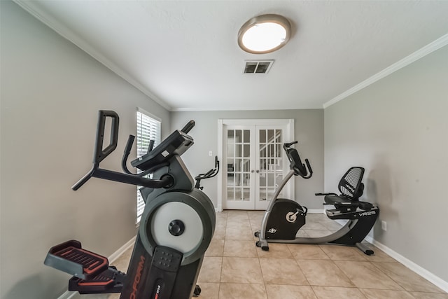 workout area featuring french doors, ornamental molding, and light tile floors