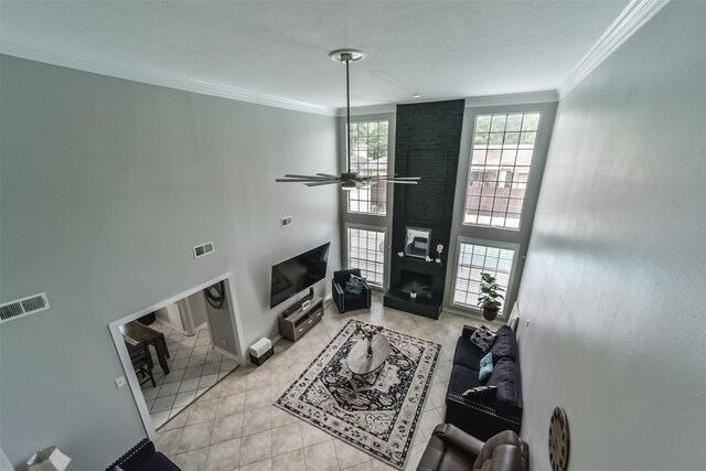 living room with brick wall, a towering ceiling, ceiling fan, and light tile flooring