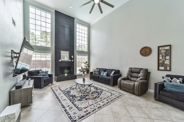 tiled living room featuring high vaulted ceiling, a large fireplace, ceiling fan, and brick wall