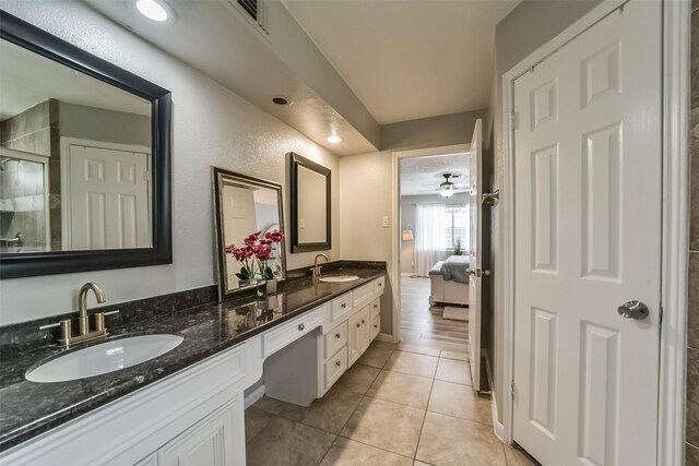 bathroom featuring wood-type flooring, oversized vanity, and dual sinks