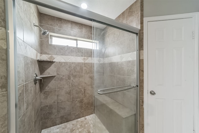 bathroom featuring a shower with door