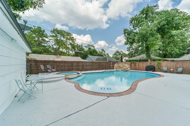 view of swimming pool with an in ground hot tub and a patio