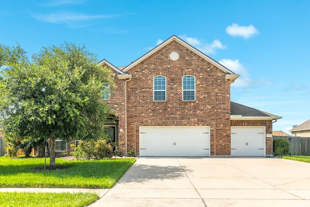 view of front property with a garage and a front yard