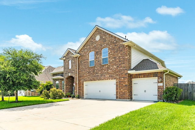 front facade featuring a garage and a front lawn