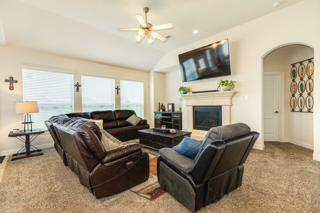 living room featuring carpet flooring, ceiling fan, and vaulted ceiling