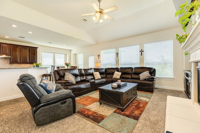 carpeted living room with ceiling fan