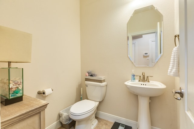 bathroom featuring toilet and tile floors