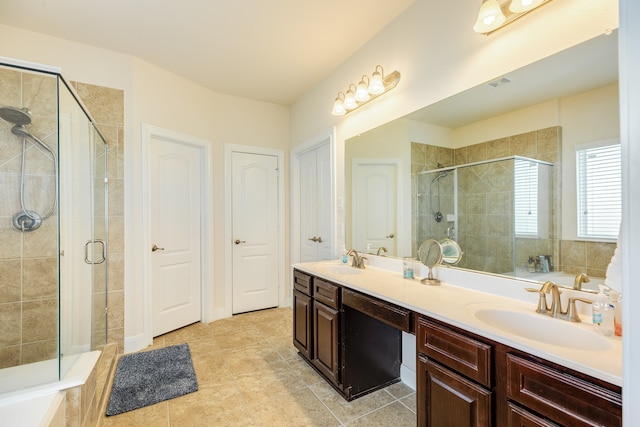 bathroom featuring a shower with door, dual bowl vanity, and tile flooring