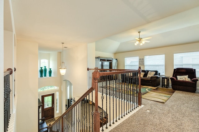 stairway featuring vaulted ceiling, carpet, and ceiling fan