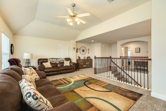 carpeted living room featuring ceiling fan and vaulted ceiling